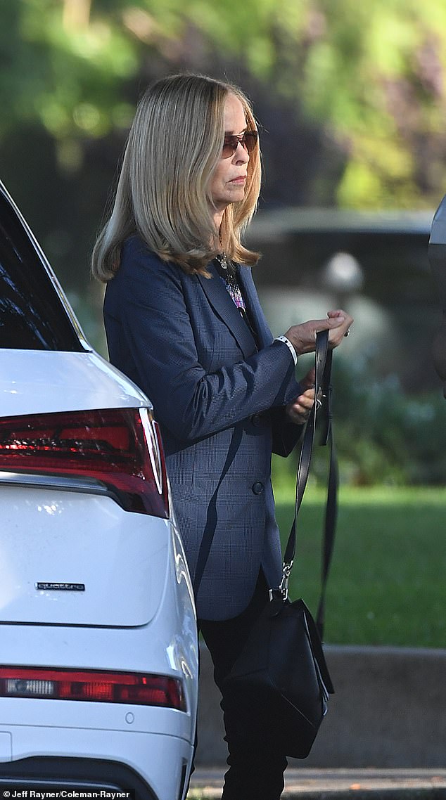 Bach was spotted headed to the morning meeting on October 28 wearing sleek black slacks, a graphic T-shirt layered under a sharp blue blazer and pink-and-black sneakers