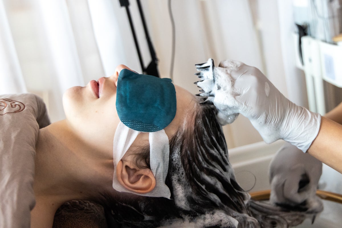 a client receives treatment to remove hair product and pollutant residue