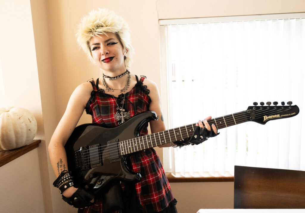 woman playing electric guitar