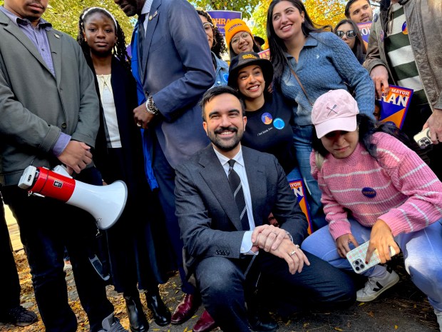 Zohran Mamdani poses with supporters in Harlem this afternoon.