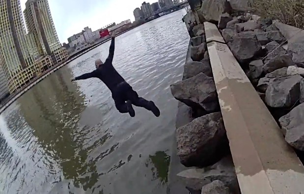 NYPD Officer Wilmer Guerrero jumps into the Harlem River near East 142nd Street in Manhattan to rescue a 16-year-old girl on Tuesday.
