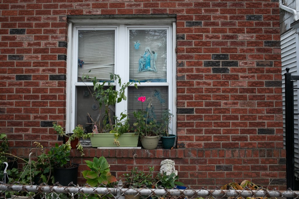 A Corona home had a statute of Jesus and picture of the Virgin Mary on a front window.