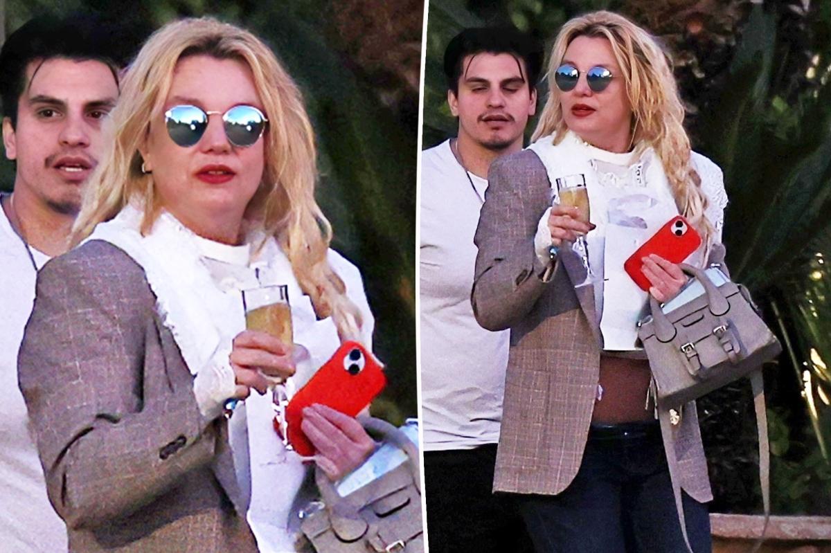 Britney Spears spotted walking to car with champagne flute as family remains concerned over erratic behavior