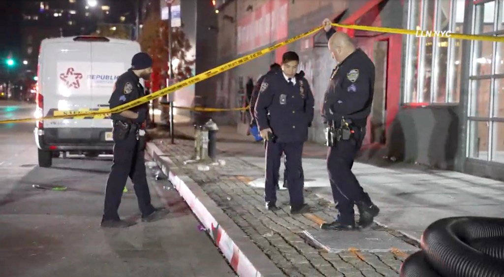 Police officers securing the scene of a shooting outside the Harbor NYC Club in Midtown Manhattan.