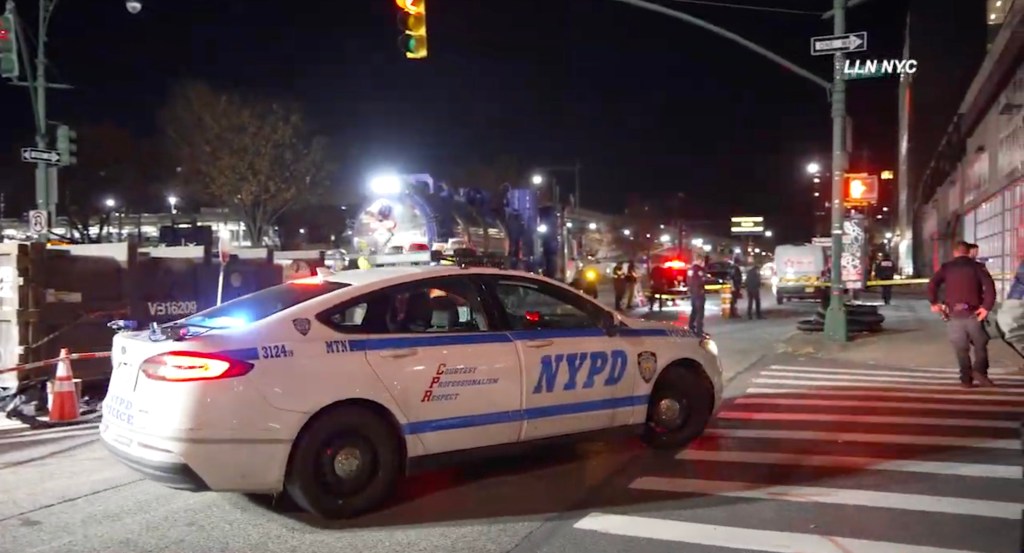 Police car and officers at the scene of a shooting outside Harbor NYC Club.