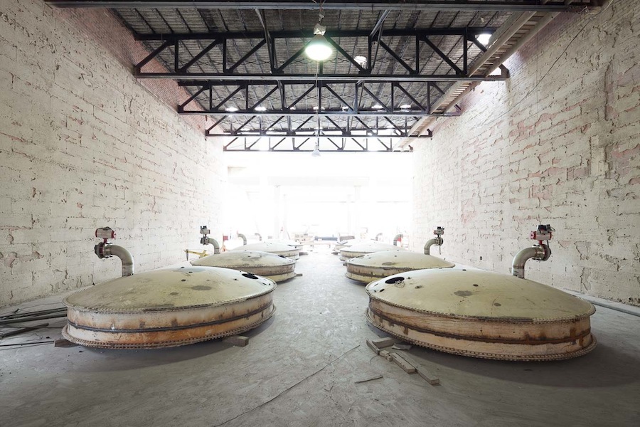 Salvaged tank ends await reuse in Hotel Emma's Elephant Cellars Ballroom. Photo by Scott Martin.