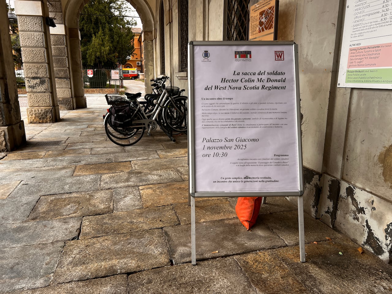 A sign outside a rocky building