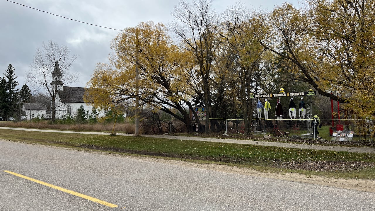A display showing was appears to depict people hanging from what looks like a gallows. 