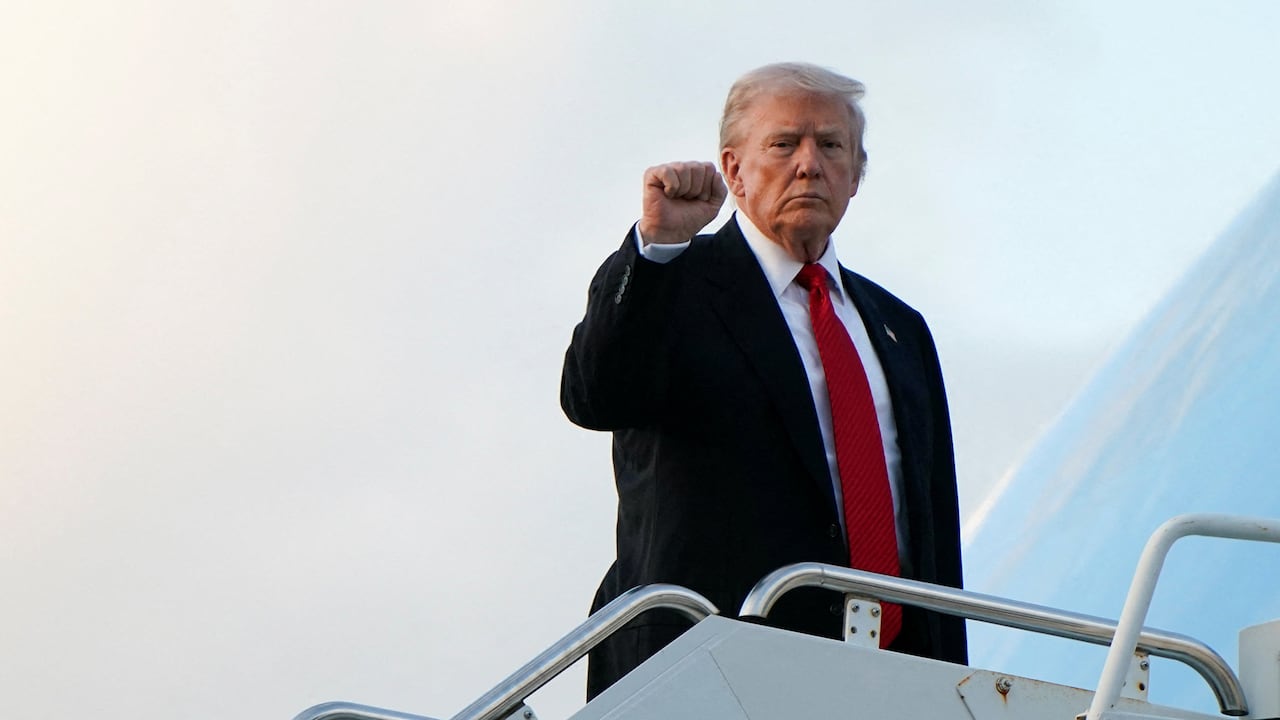 A man in a suit with his fist in the air. 