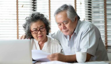 A senior couple reviews their finances and plans their retirement.