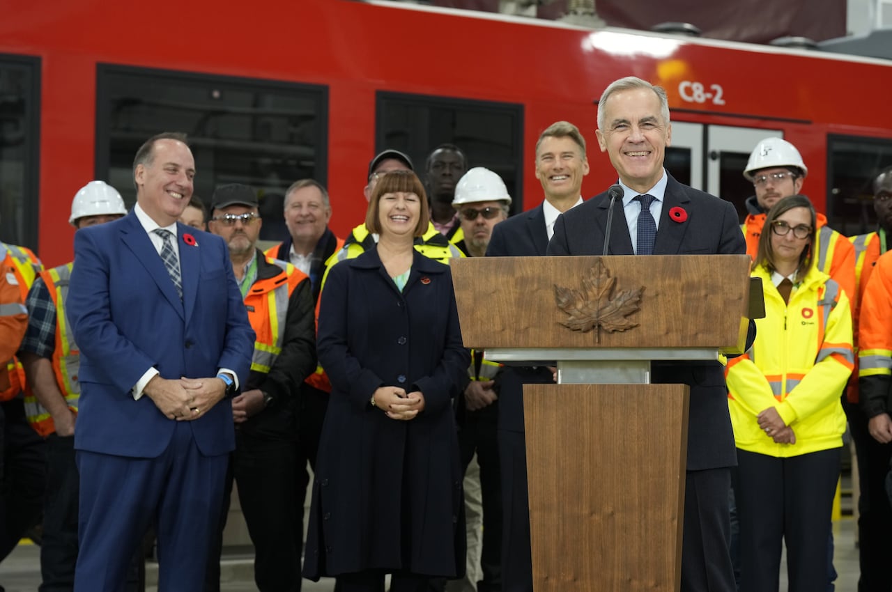 MP for Acadie-Annapolis Chris d’Entremont  and MP for Orleans Marie-France Lalonde look on as Prime Minister Mark Carney responds to questions during an event in Ottawa, Wednesday, Nov. 5, 2025. 