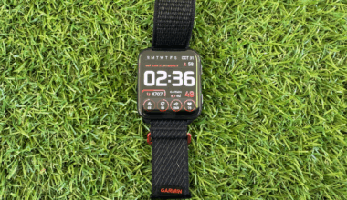 Garmin Venu X1 smart watch with black wrist band displayed on grassy background