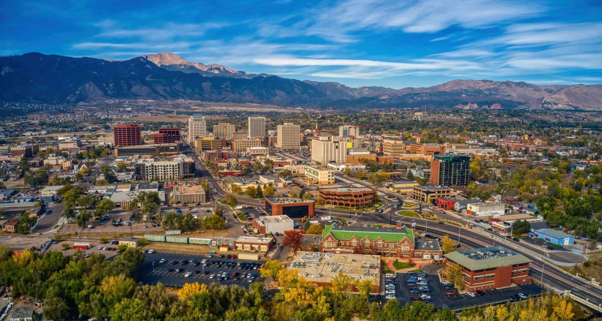 Aerial picture of the overhead view of Colorado springs with building and trees with autumn colors.
