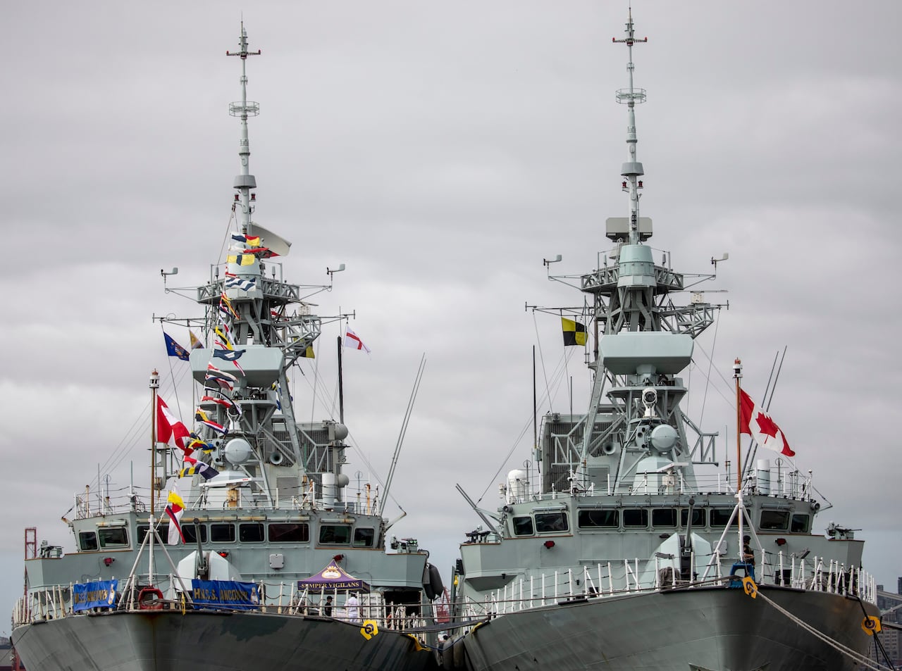 Two warships are seen on a cloudy day.