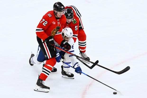 Toronto Maple Leafs left wing Nicholas Robertson (89) moves the puck against Chicago Blackhawks defenseman Alex Vlasic (72) and defenseman Connor Murphy (5) during the third period of an NHL hockey game, Saturday, Nov. 15, 2025, in Chicago. (AP Photo/Matt Marton)