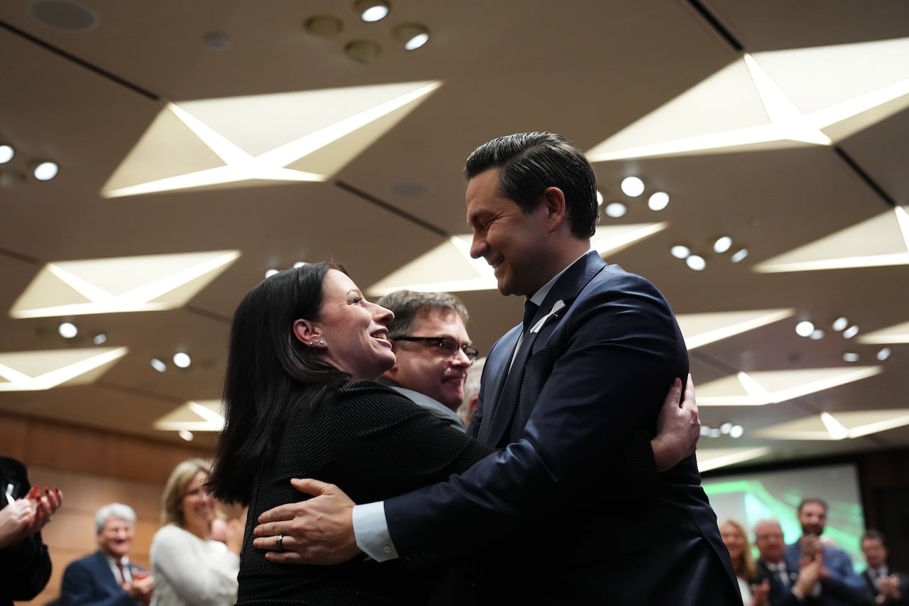 Conservative Leader Pierre Poilievre hugs MP Shannon Stubbs after addressing the National Conservative Caucus in Ottawa on Wednesday, Dec.6, 2023.