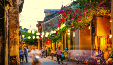 busy Street at duskSilk Lanterns in Hoi An an ancient city in Vietnampeople and scooter in motion blur.