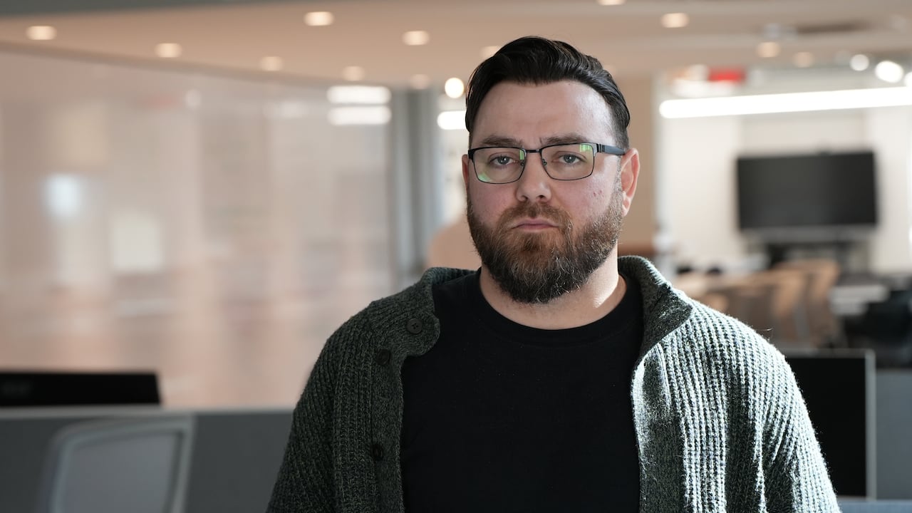 A man standing in an office.