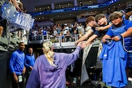 Fans reach out to Dallas Wings guard Paige Bueckers as she leaves the arena after an NBA...