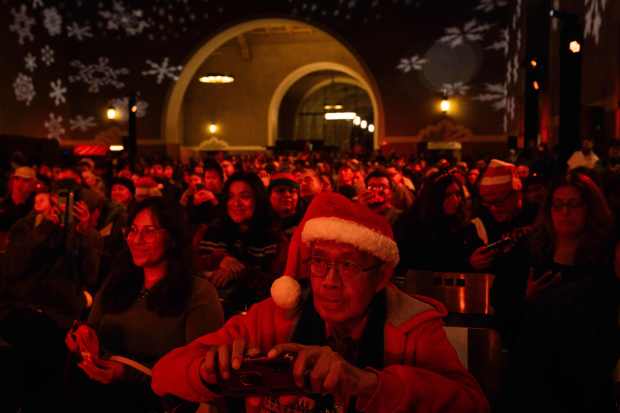Joe Guerrero, of Los Angeles, takes pictures during the 10th...