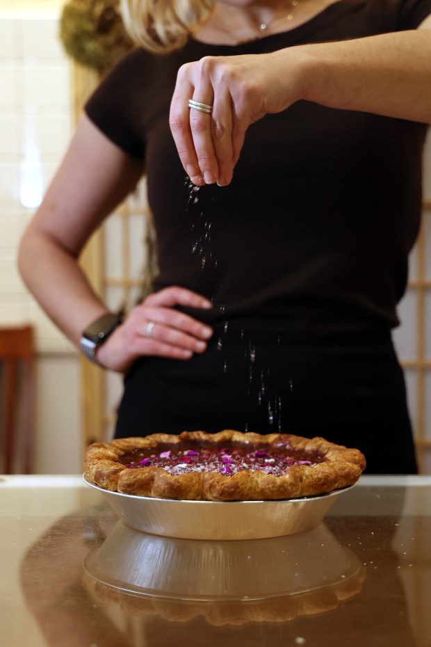Asa Balanoff Naiditch salts her Dying The Honey Pink pie at the pastry shop Blame Butter, 168 W. Huron Street in Chicago, Nov. 21, 2025. (Terrence Antonio James/Chicago Tribune)