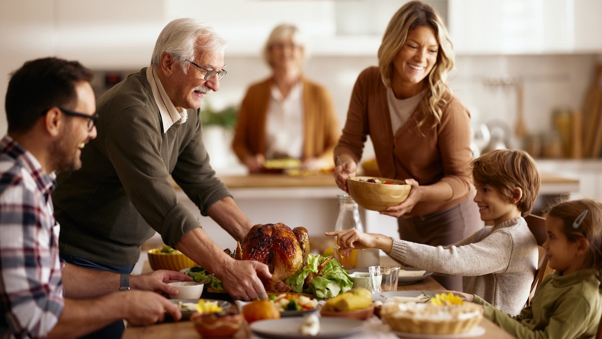 Family setting the table for Thanksgiving