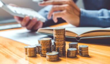 Saving money concept Man hand putting Row and coin Write Finance Saving money concept Man hand putting Row and coin Write Finance.