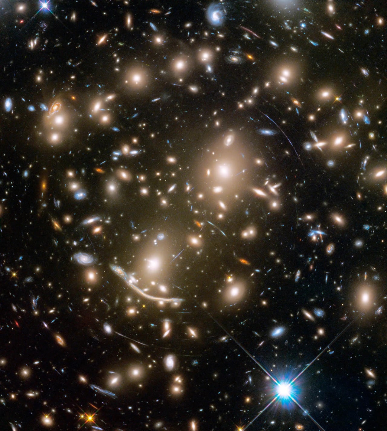 An image of space with several bright galaxies and arcs.