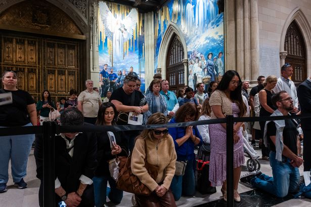 NEW YORK, NEW YORK - SEPTEMBER 21:  People attend a mass and ceremony for a new mural dedicated to New York City’s immigrant communities and honoring the city’s first responders at St. Patrick’s Cathedral on September 21, 2025 in New York City. The mural, painted by artist Adam Cvijanovic, honors the 1879 Apparition at Knock, Ireland, and the faith of generations of immigrants to New York. The 25-foot-tall mural, which is the largest permanent artwork commissioned for the cathedral in its 146-year history, arrives at a time when many immigrant communities in New York and across the country are facing arrests and deportations from the Trump administration. (Photo by Spencer Platt/Getty Images)