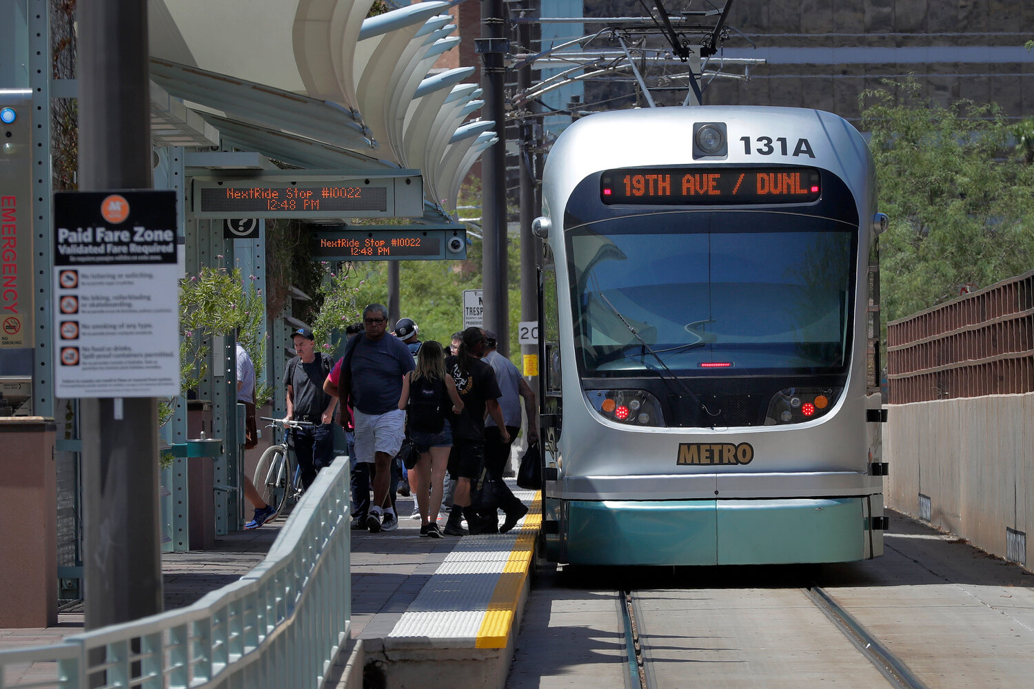 A light rail train stops for passengers, Monday, Aug. 26, 2019 in Tempe.