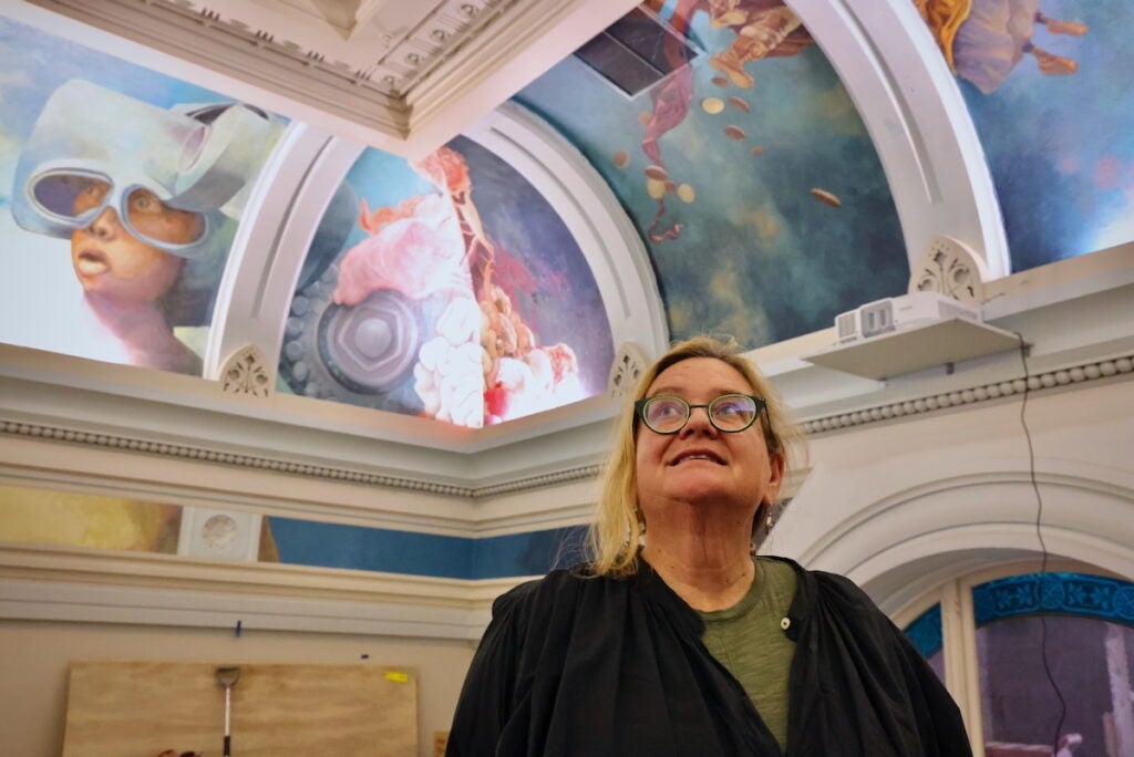 Meg Saligman looks up at the painted ceiling in the ''Ministry of Awe