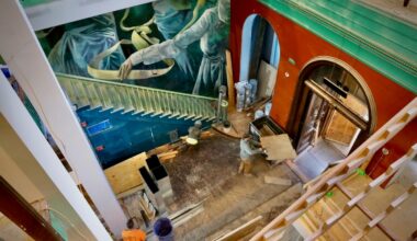 Construction workers and artists transforming Manufacturers National Bank in Old City into the