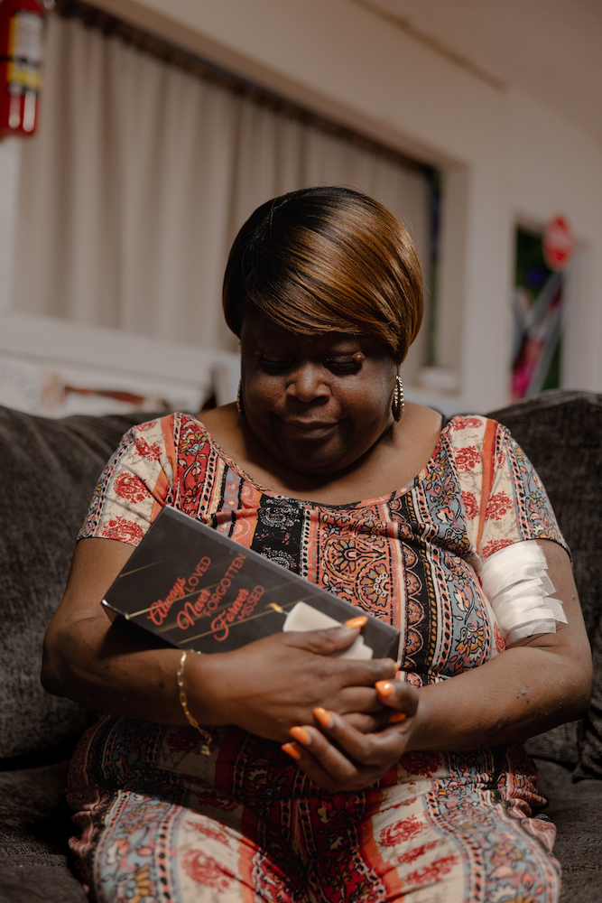 Walker’s mother, Pamela Walker, holds her daughter’s ashes.