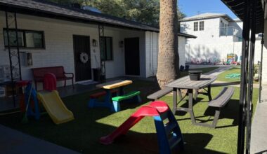 The courtyard of a Rooted in Grace Foundation apartment, with toys scattered around.