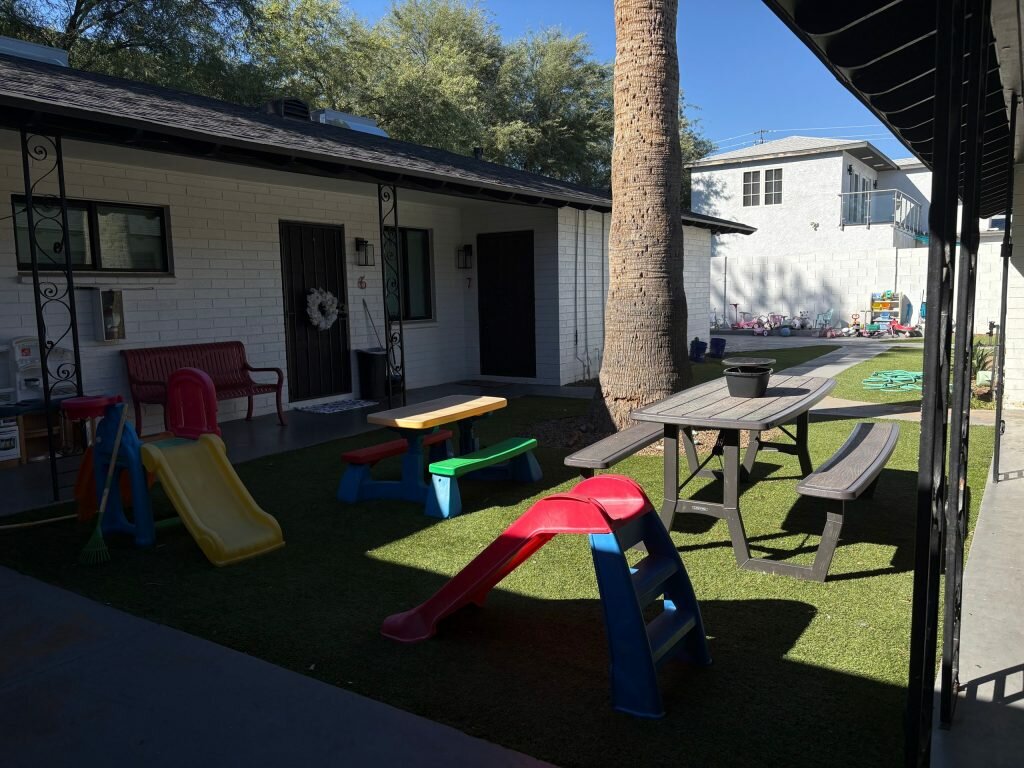 The courtyard of a Rooted in Grace Foundation apartment, with toys scattered around.