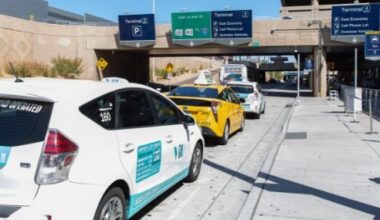 Taxi cabs wait at the curb at Phoenix Sky Harbor International Airport.