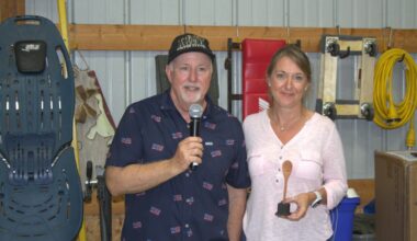 Host Preston Mangas handed non-traditional division winner Rebecca Shearer her trophy for her white chili.