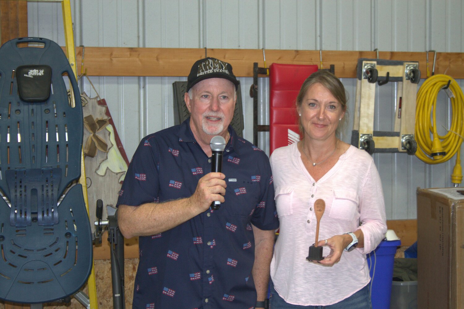 Host Preston Mangas handed non-traditional division winner Rebecca Shearer her trophy for her white chili.