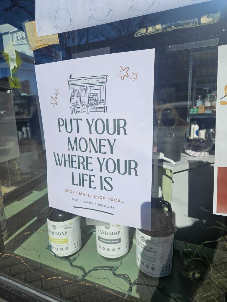 Put Your Money Where Your Life Is sign at Gaia’s Market & Refillery in Homewood, Illinois