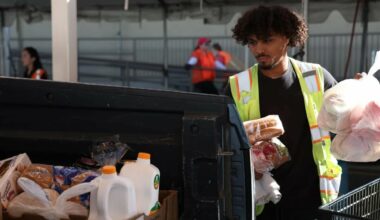 Volunteer Tristan Pall packs food boxes in a truck bed at St. Mary’s Food Bank in Phoenix on Oct. 30, 2025.