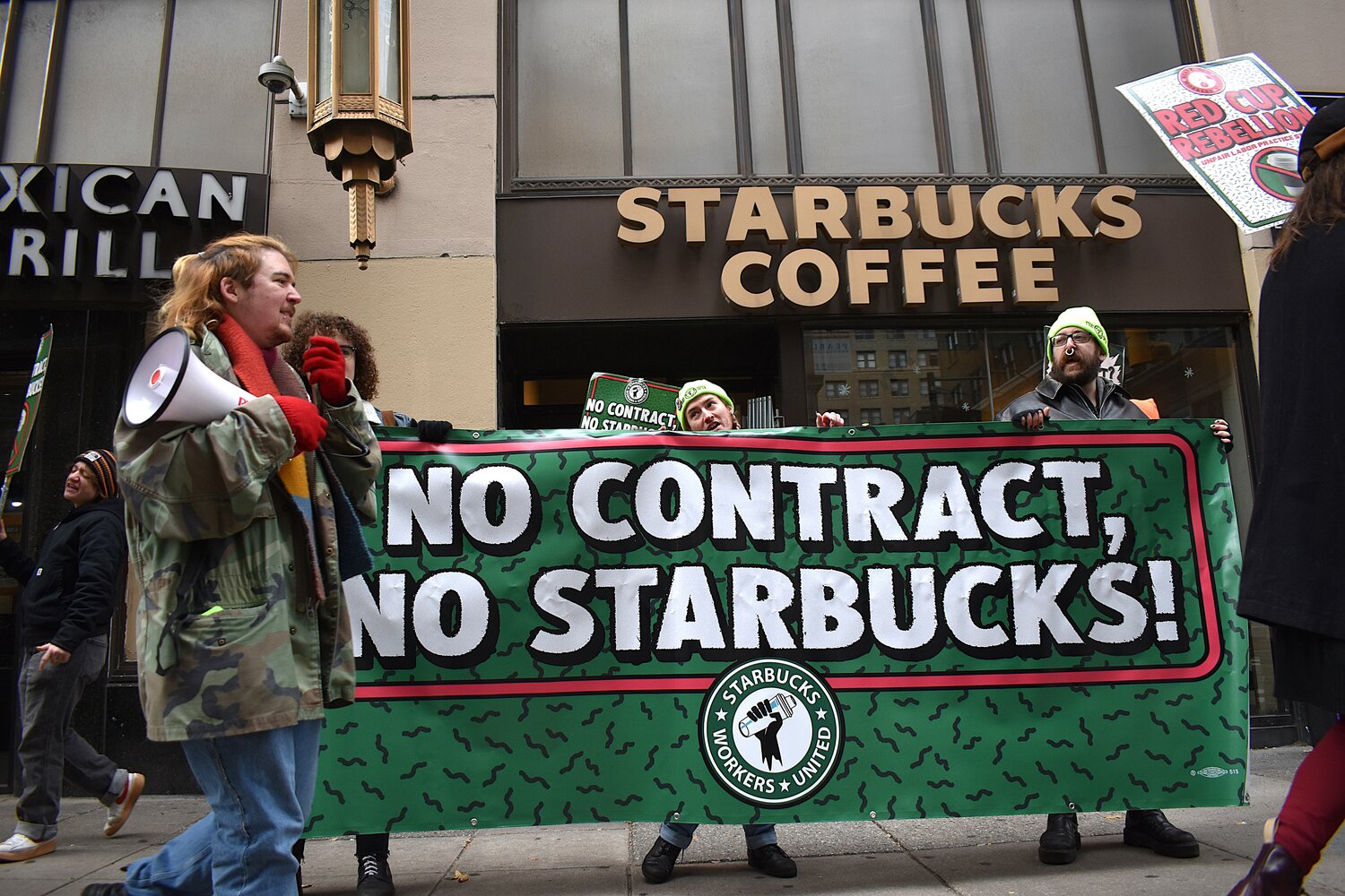 Striking Starbucks workers picket Tuesday, Nov. 25, outside the company