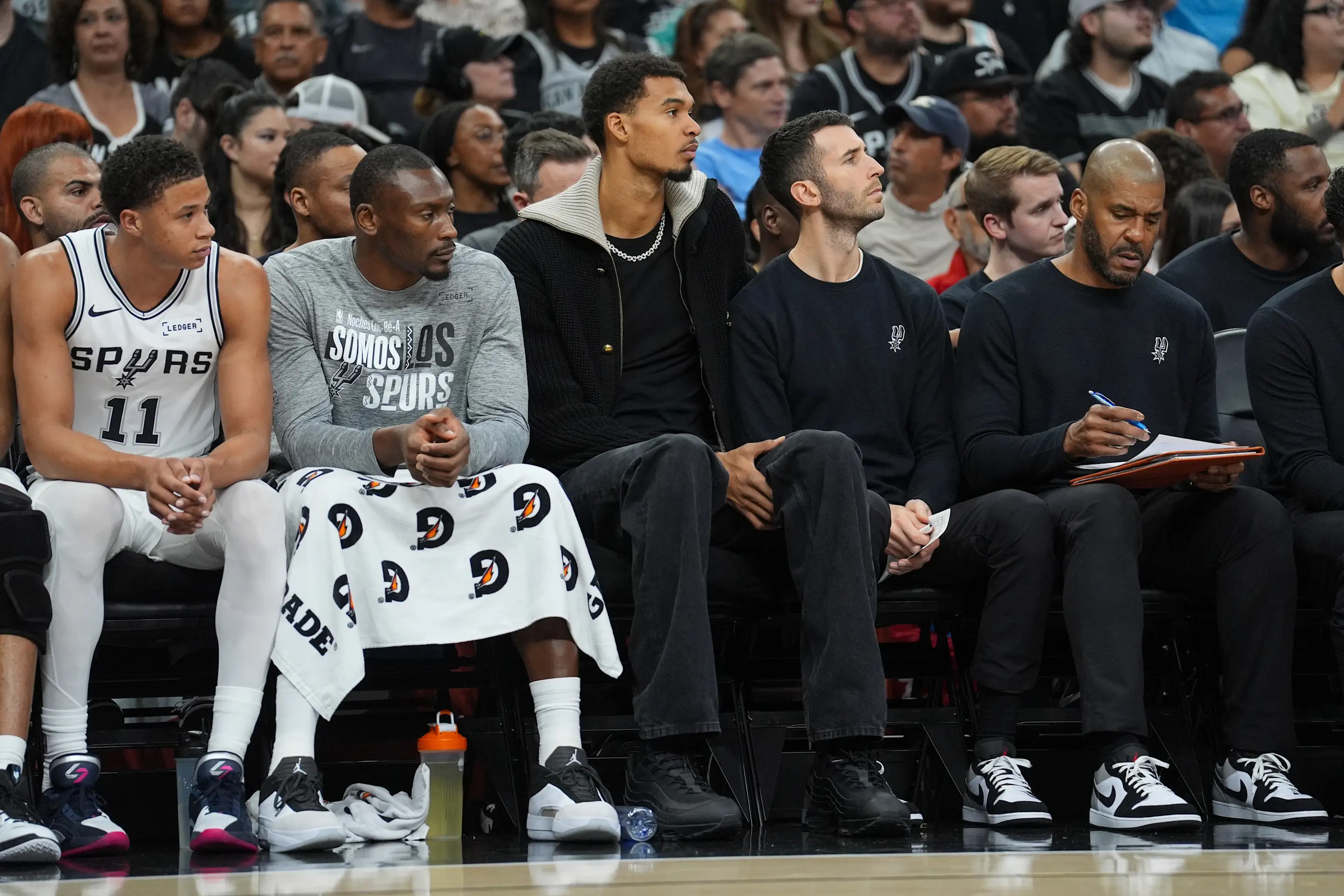 Nov 16, 2025; San Antonio, Texas, USA; San Antonio Spurs forward Victor Wembanyama (1) on the bench in the first half against the Sacramento Kings at Frost Bank Center. Mandatory Credit: Daniel Dunn-Imagn Images