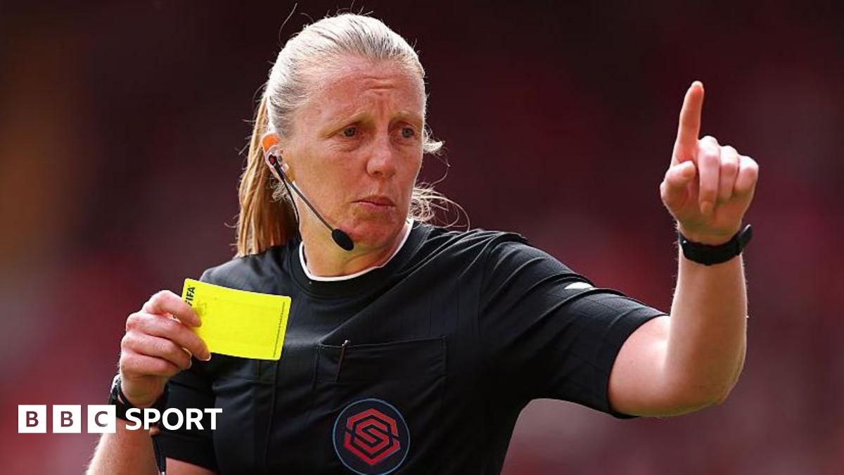 Referee Lisa Benn holding a yellow card
