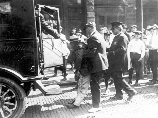 Police remove the body of a Black man killed during...