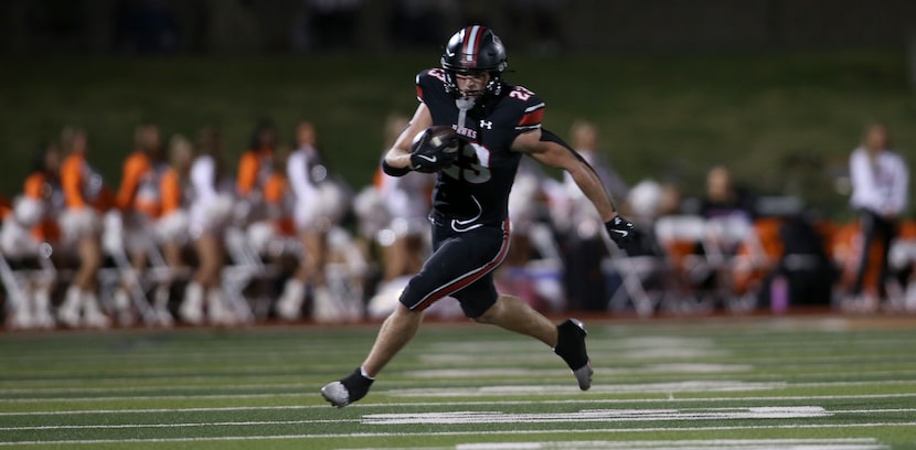 Rockwall Heath running back Carter Zahm (23) sprints deep into the Rockwall secondary on a...