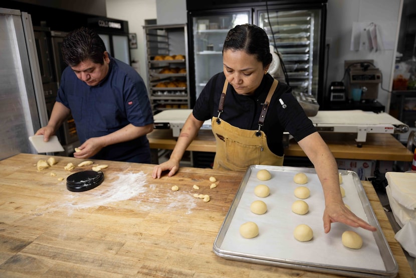 Owners Ismael Trejo and wife Maria Becerra prepare pan de muerto, the staple bread for Dia...