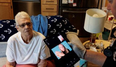 Paula Ward, a 71-year-old South Boston resident enrolled in Mass General Brigham Home Hospital, waits as a program paramedic, Charlie Carey, sets up a video call for her with her MGB physician's assistant during a home visit in September.