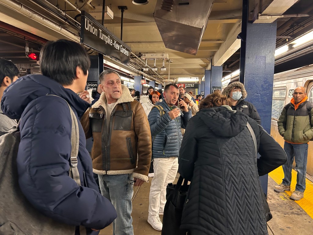Victims Carlos Plasencia and Gjon Oroshi, with visible facial injuries, on the Union Turnpike-Kew Gardens subway platform.