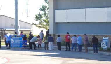 People are lining up to vote on Election Day outside of a library in Universal City, Texas.