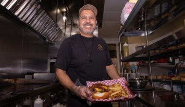 Tony Marron, owner of Uncle Tony's, posing with a fresh burger